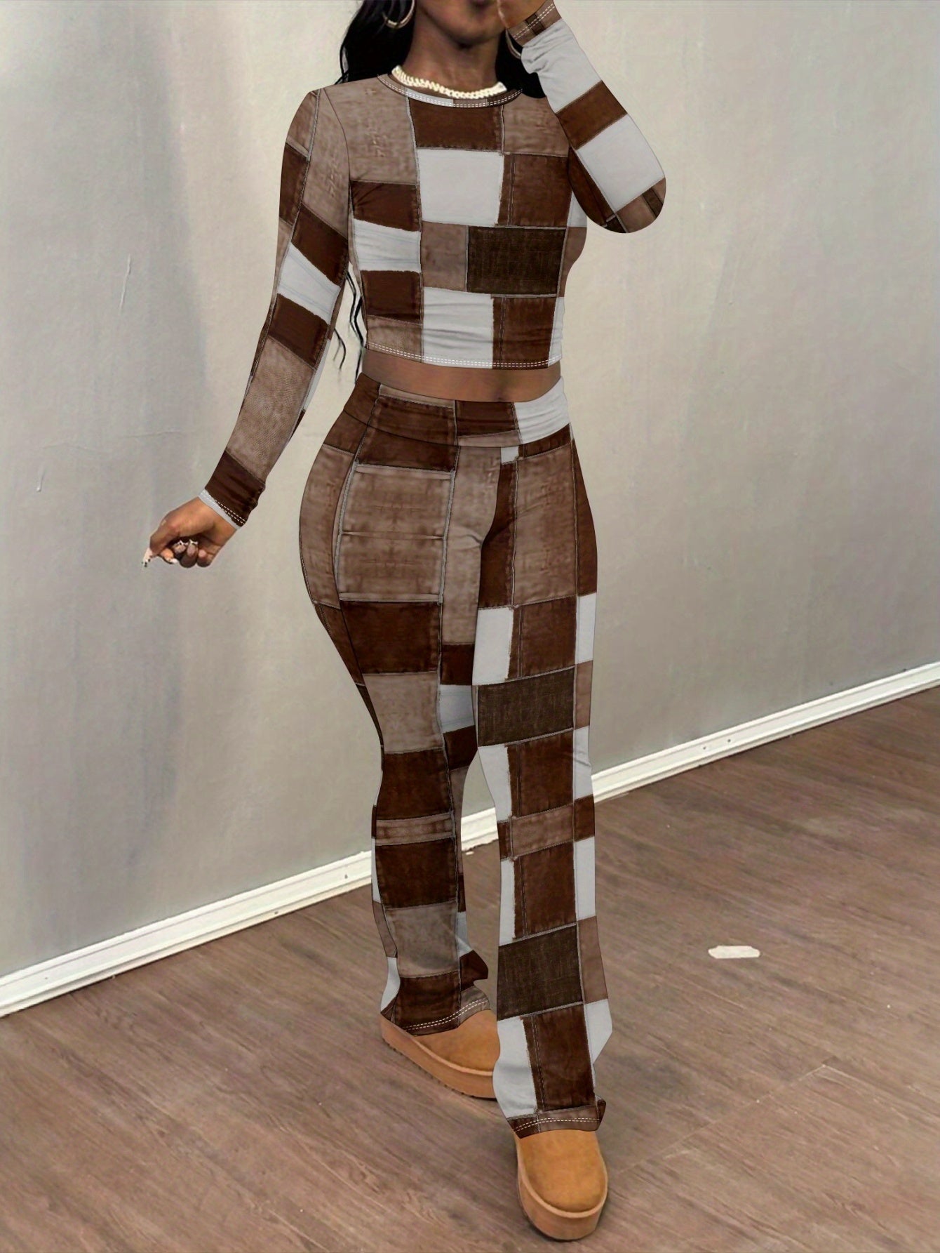 European and American style brown and white patchwork print two-piece set for women: long-sleeved cropped top + slightly flared trousers. Features visible stitching details for a unique and look.